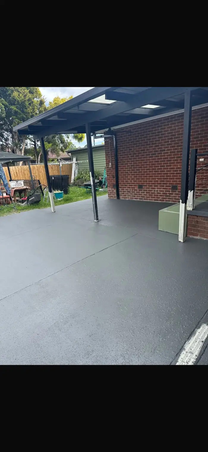 After — cracked patio ground, sealed and restored in charcoal