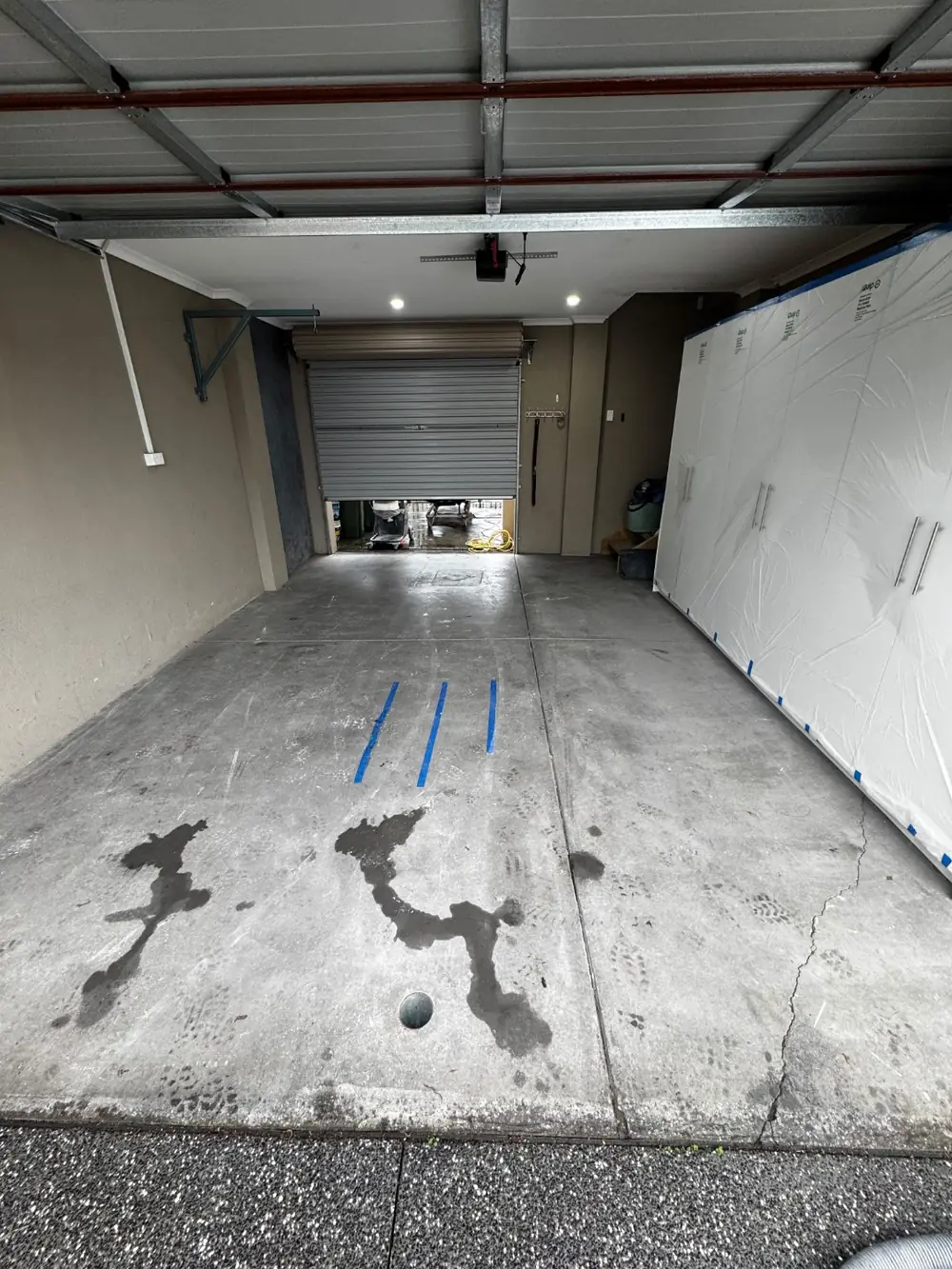 Before — stained bare concrete garage, Mill Park