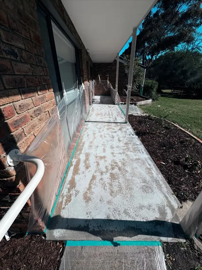 Before — weathered verandah concrete, masked and prepped